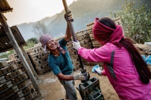 Two workers producing bricks in Nepal